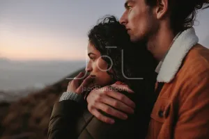 Beautiful couple looking at view from mountain