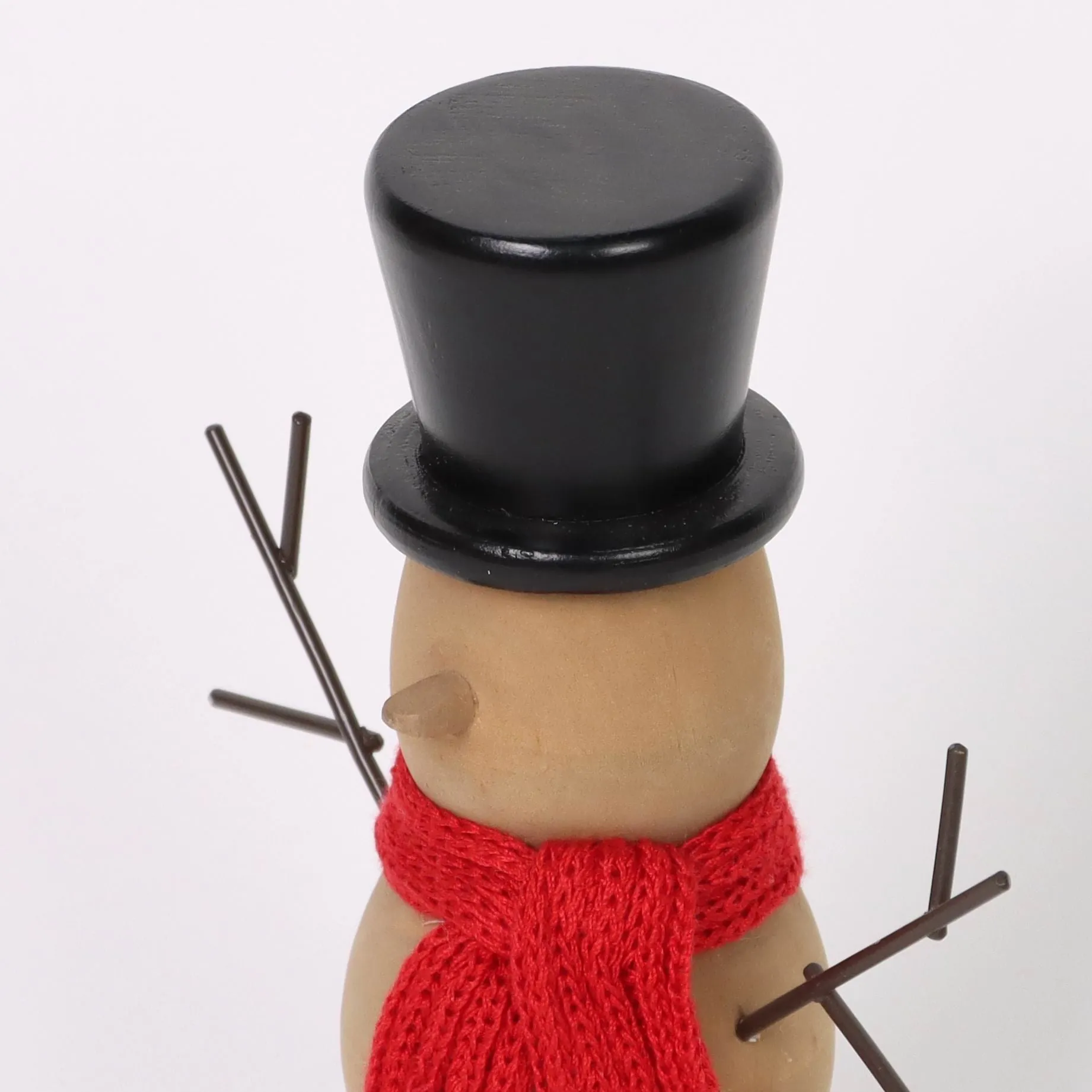 Wooden snowman with red knitted scarf